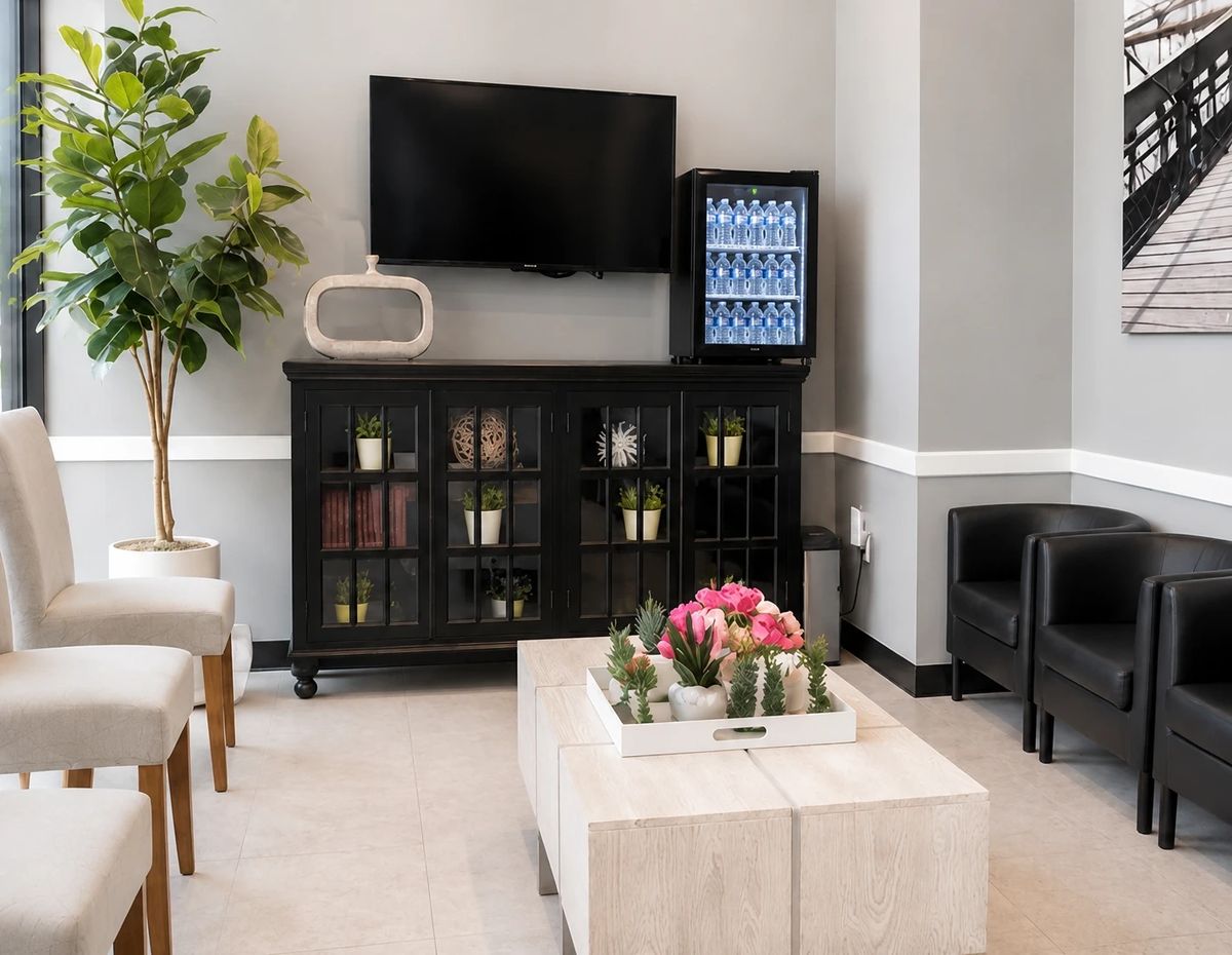 Patient lounge with TV and complimentary water at Smiley Cypress Dental Care
